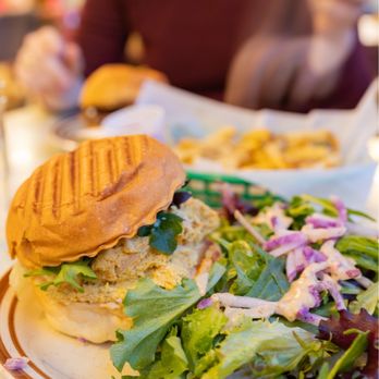 The Root Cafe signature dishes The Root Burger, Pimento Cheeseburger, Eggs Benedict, Biscuits and Gravy